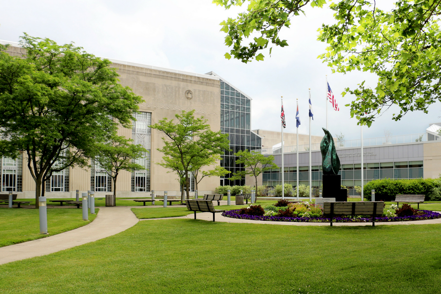 Main Library front lawn showing green trees and flags