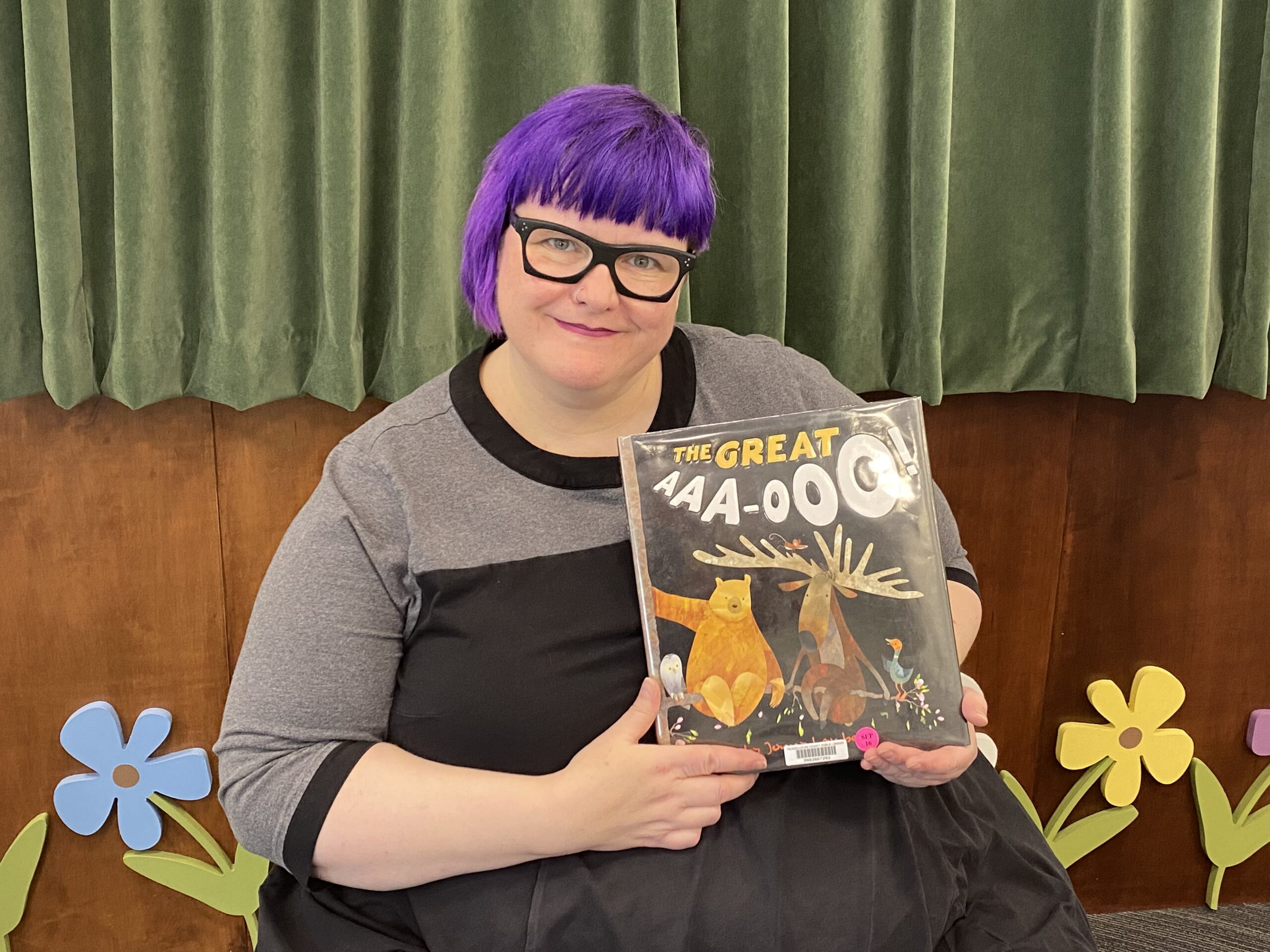 Librarian holding The Great Aaa-ooo picture book