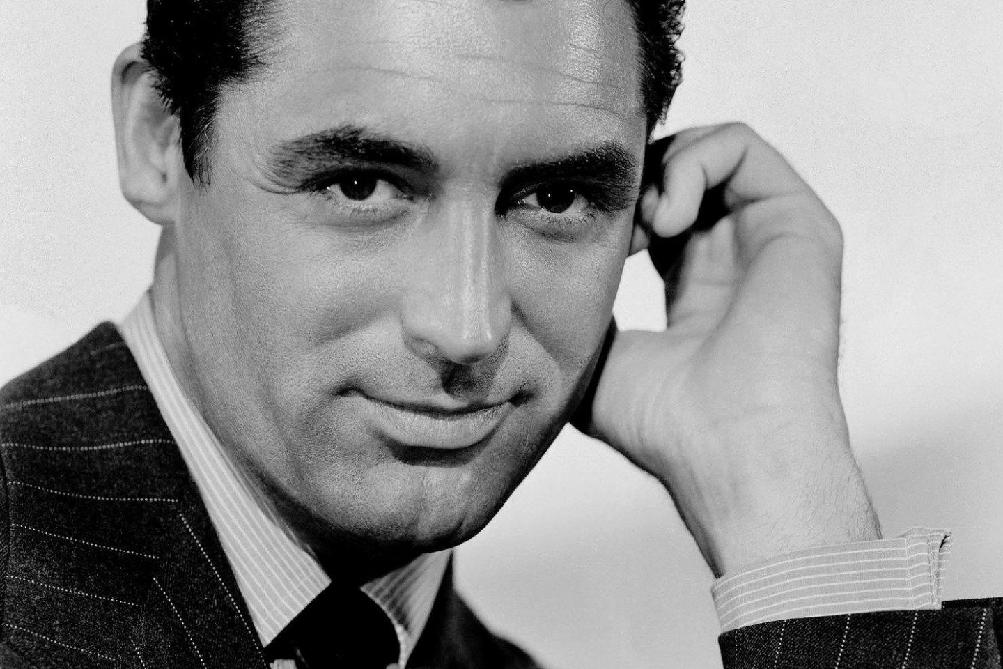 A black and white portrait of Cary Grant