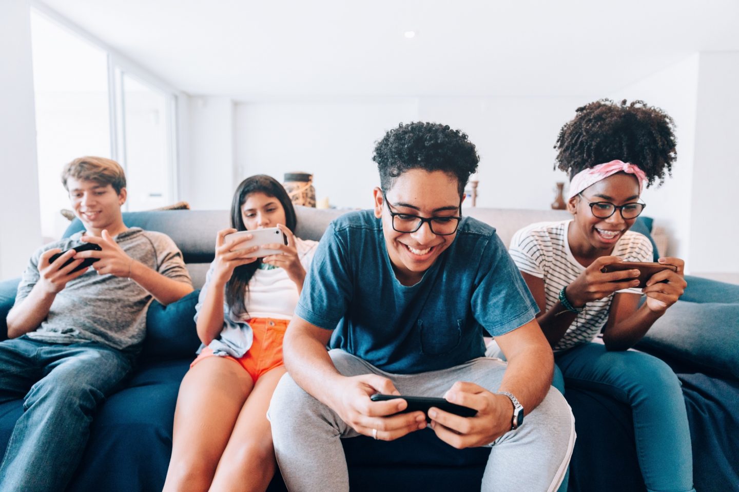 Group of young friends playing mobile games