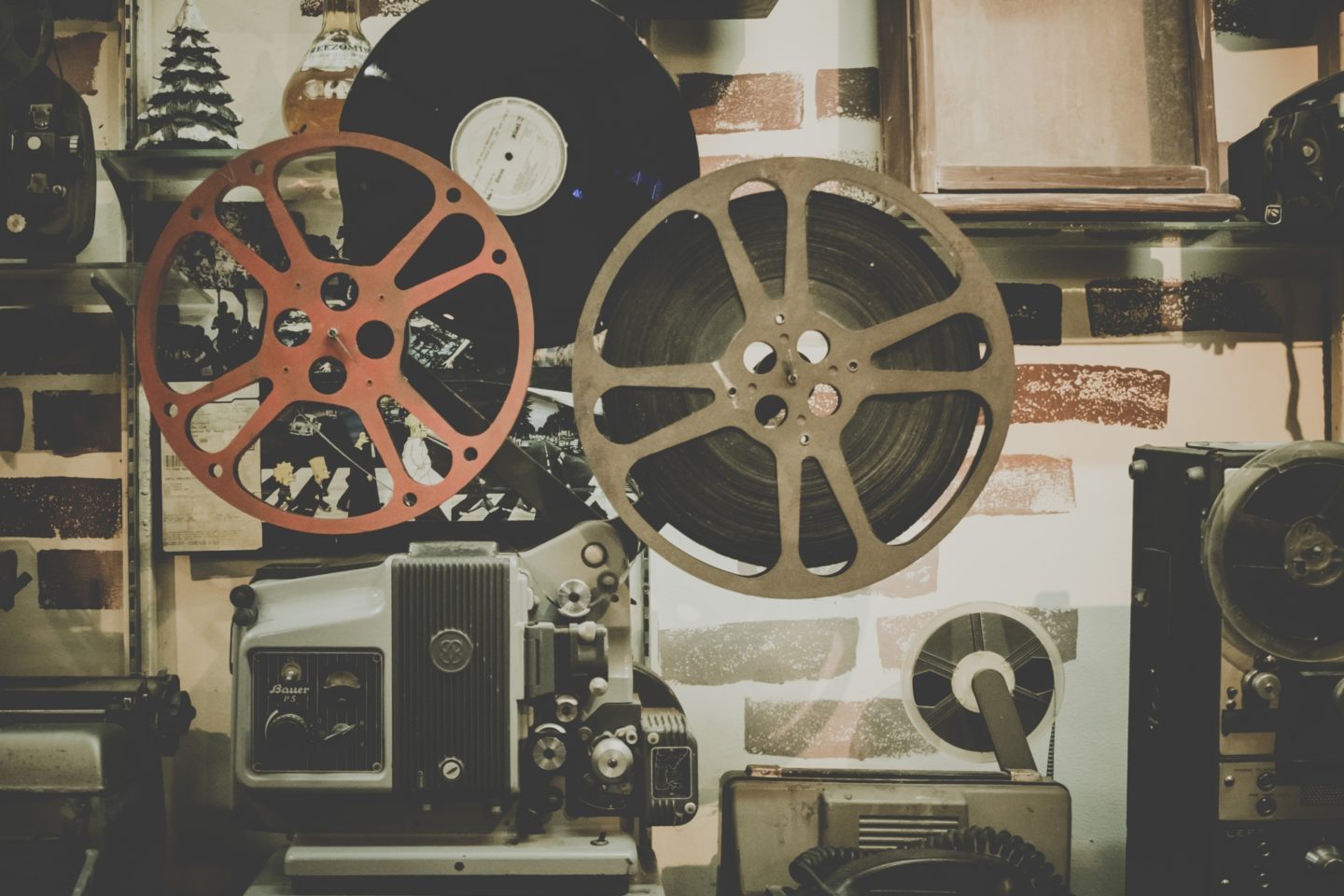Side view of an old projector with movie film reels.