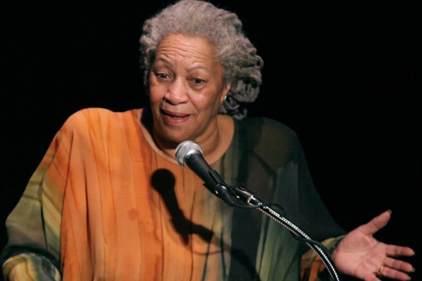 View of Toni Morrison speaking into a microphone during a presentation.