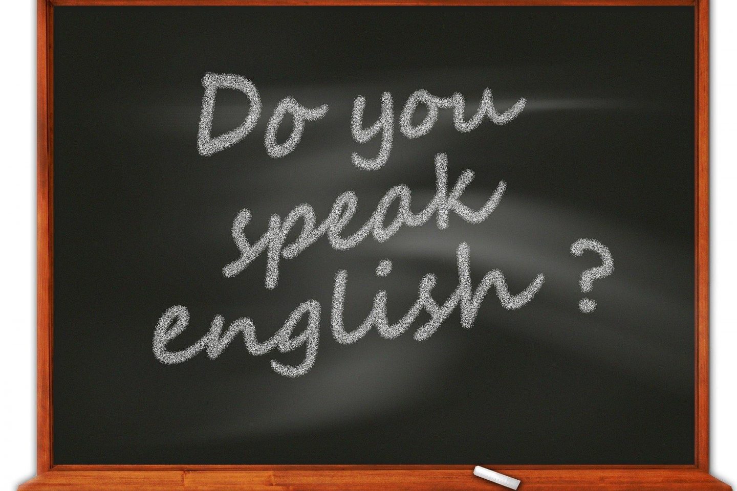 An illustrative version of a chalkboard is seen with the words "Do you speak english?" written in chalk on the board.