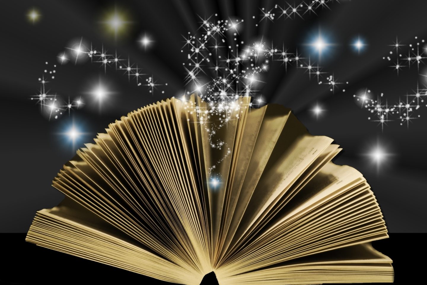 A book has its pages flipping through as blue, yellow, and white sparkles emanate from its pages on a black background.