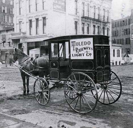 LH Webpage Image A black-and-white photo shows a horse attached to a carriage. The carriage has a sign that reads "Toledo Railways Light and Co."