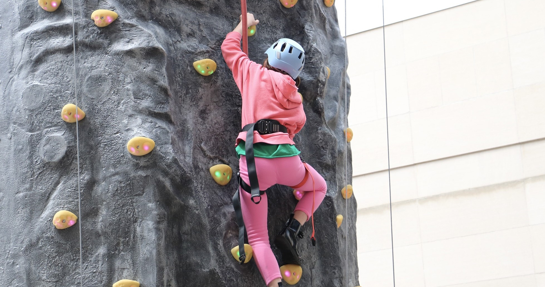 Metroparks wall climbing Toddler looking at a bin of books.