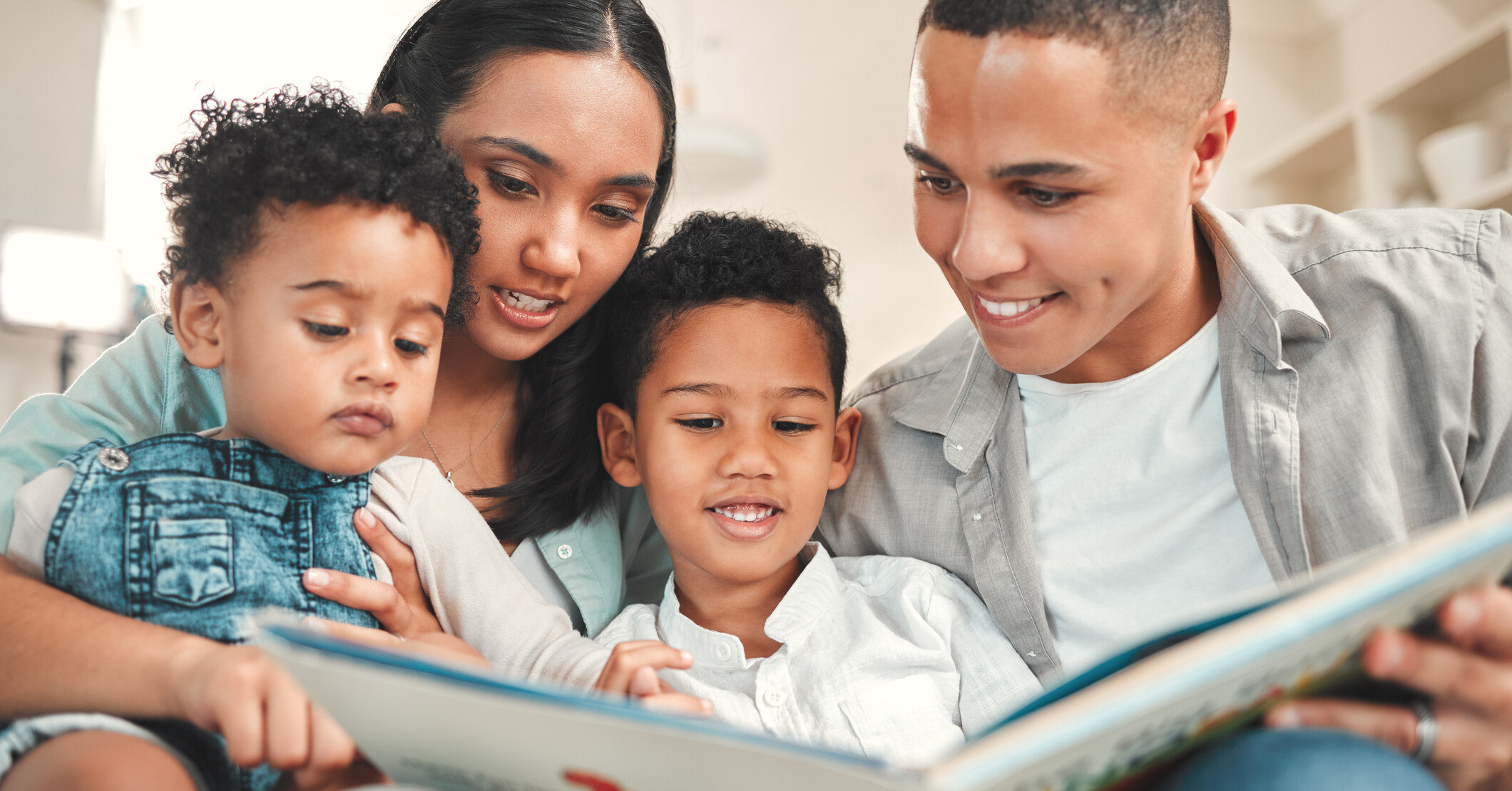 A family reads a book together.