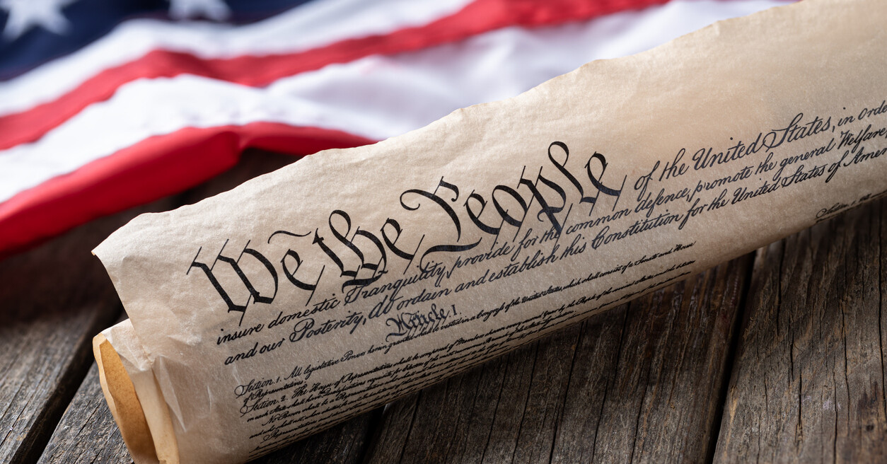 U.S. Constitution in front of an American Flag.