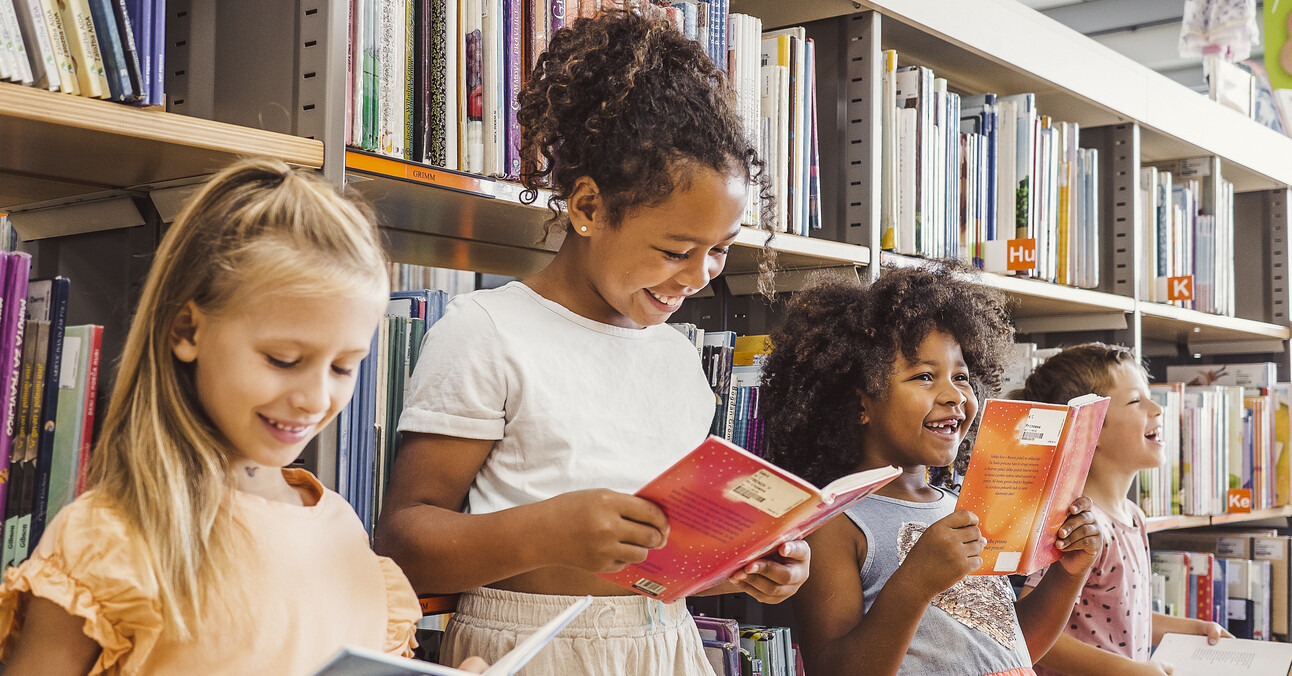 Children reading books in the library.