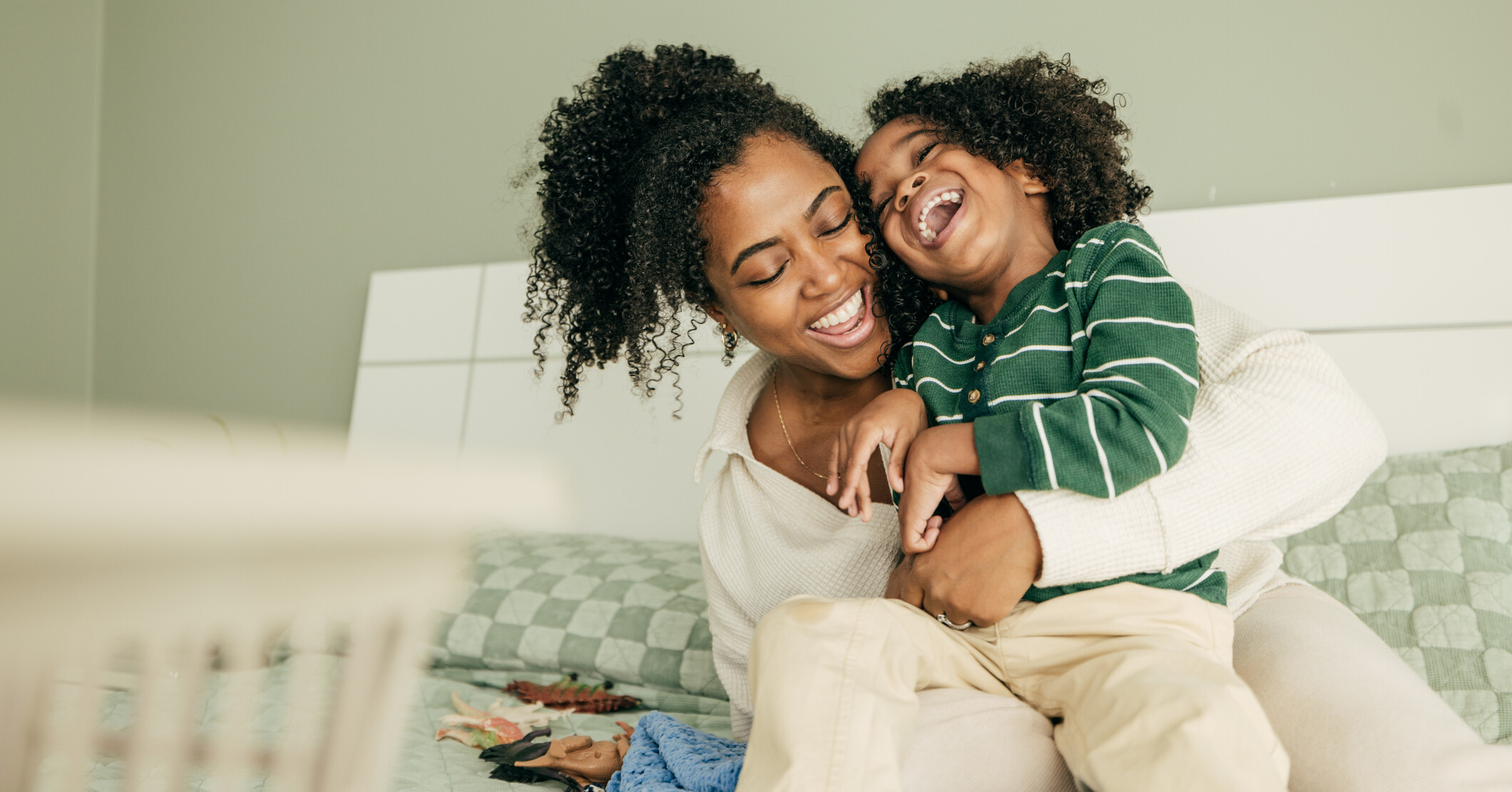 Mother and child laugh together.