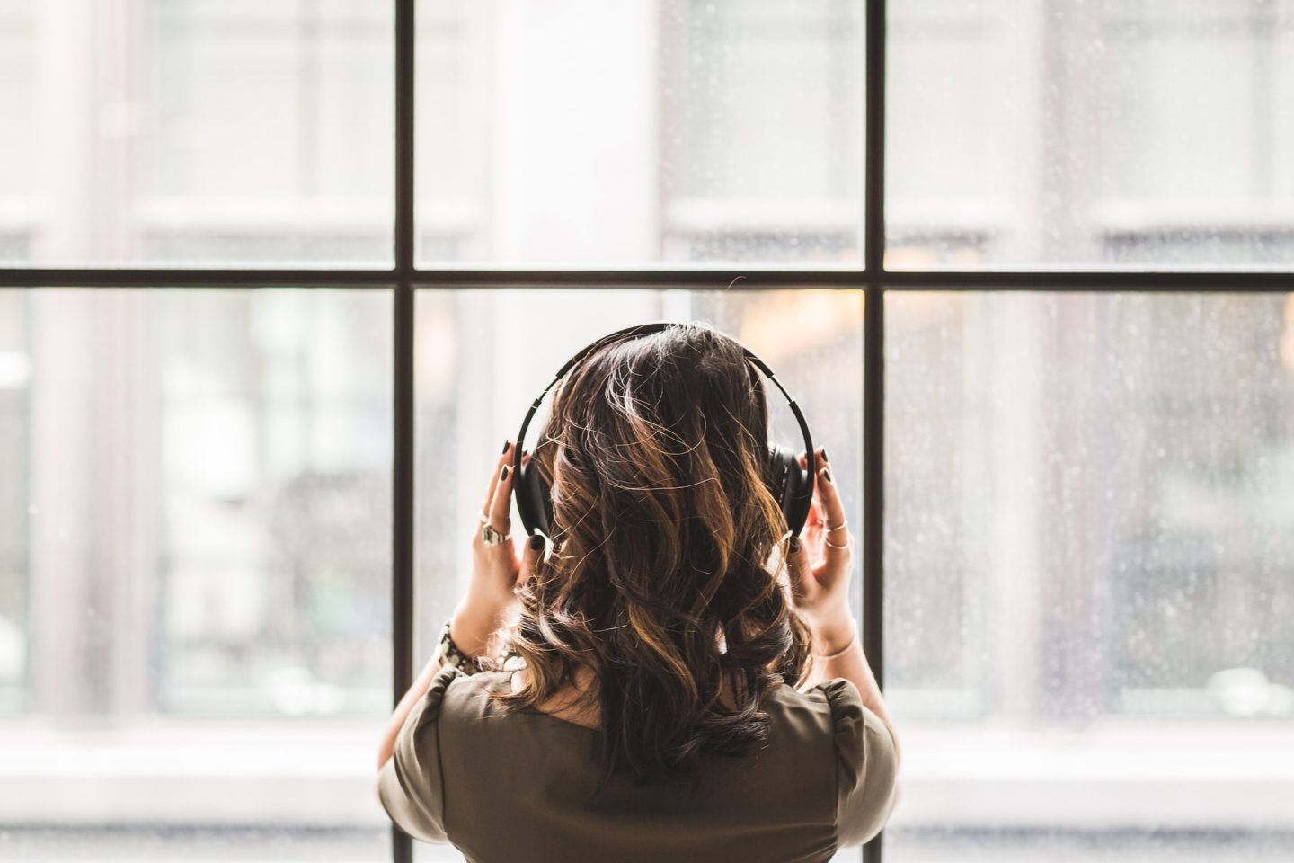 woman window headphones podcasts